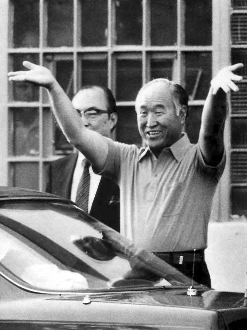 Before entering the car, Father turns around to the press, raising his arms in victory.edit2